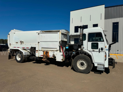 Peterbilt 2018 PB520 dump truck side view showing chassis and dump body with white cab and white bed.