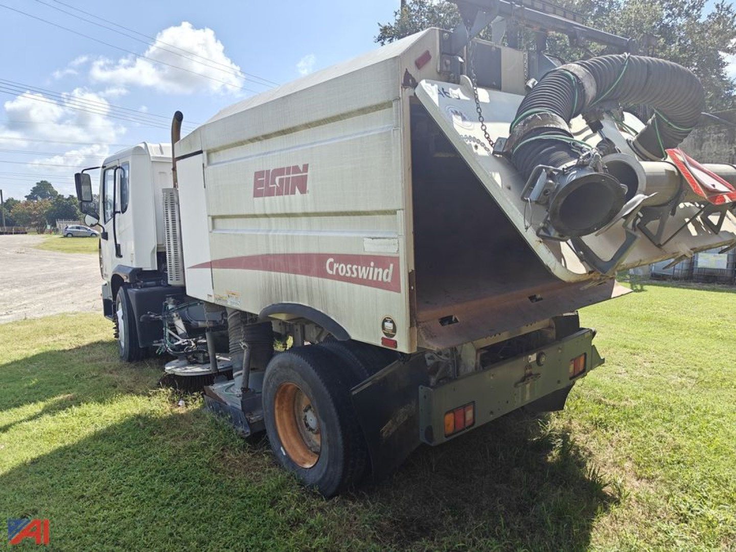 Autocar Xpert Sweeper truck rear view showing Crosswind body and hose assembly with 'EGIN' logo and exhaust components.