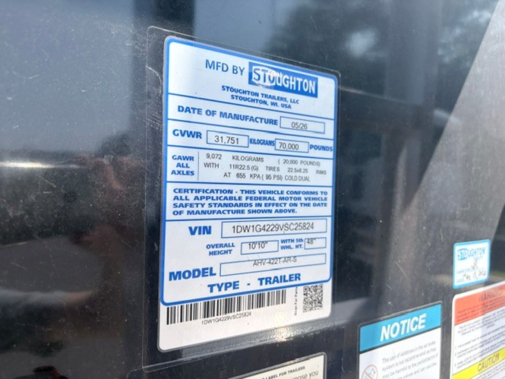 Stoughton hopper trailer data plate showing MFD BY ST/www brand label, GVWR 31,751 lb, 70,000 lb? gross vehicle weight, VIN 1DW1G4229VSC25824, model and trailer information.