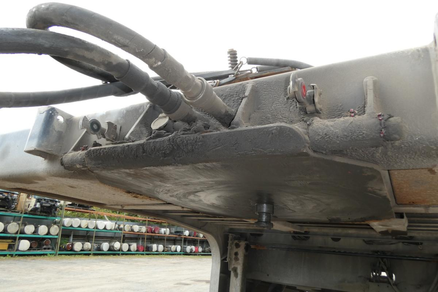 Landoll 435B-53 trailer undercarriage with hydraulic lines and metal frame, showing trailer underside and hitch area.