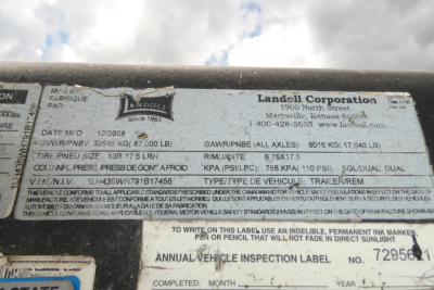 Trailer identification label on Landoll 435B-53 showing manufacturer info, GVWR, GAWR, and VIN details.