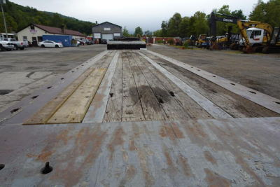 Trailing view of a landoll 435B-53 trailer bed showing wooden planks and metal frame.