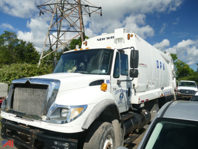 Front-left view of a white 2006 International SF647 WorkStar garbage truck showing front grille, cab, and side hopper. Visible text includes NEW WORLD and unit number 66 on cab.