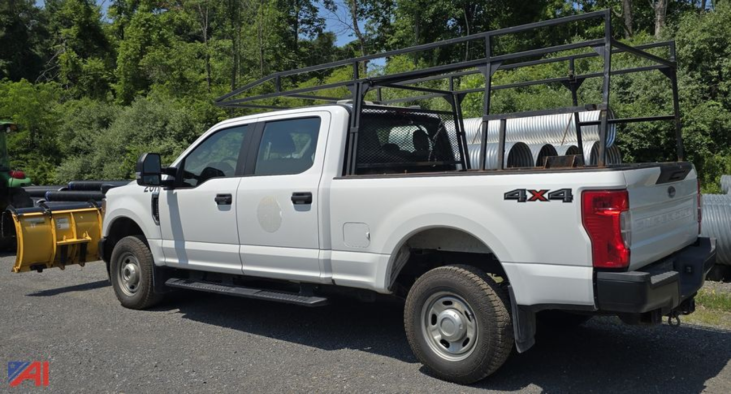Ford F-350 Super Duty XL Crew Cab 4x4 with utility rack and plow equipment in pickup truck body.