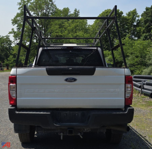 Ford F-350 Super Duty XL crew cab rear view with plow frame and tailgate text visible