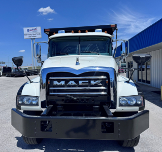 Front view of a white 2023 Mack GR84F dump truck showing bold MACK grille and bumper.