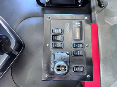 Mack GR84F cab interior showing control panel with multiple rocker switches and round 12V outlet.