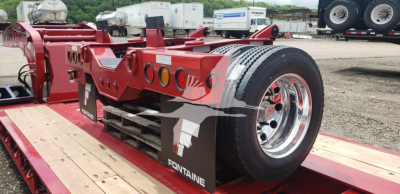Fontaine flip axle trailer chassis with red frame showing rear wheels and chrome rims; VIN 13NM05108V35P4019 visible on stock tag; Fontaine branding on mud flaps.