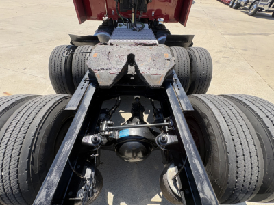 Peterbilt 579 chassis view showing rear dual axles, drive shaft, suspension, and fifth wheel mounting area.