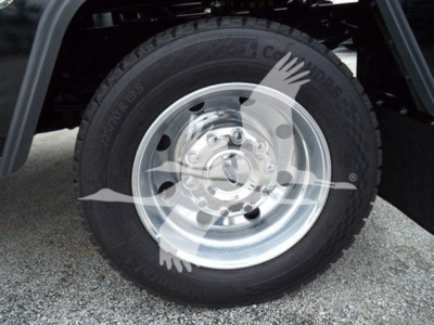 Wheel and tire close-up on a Ford F-450 front wheel showing steel rim and Goodyear tire with visible tread and sidewall details.
