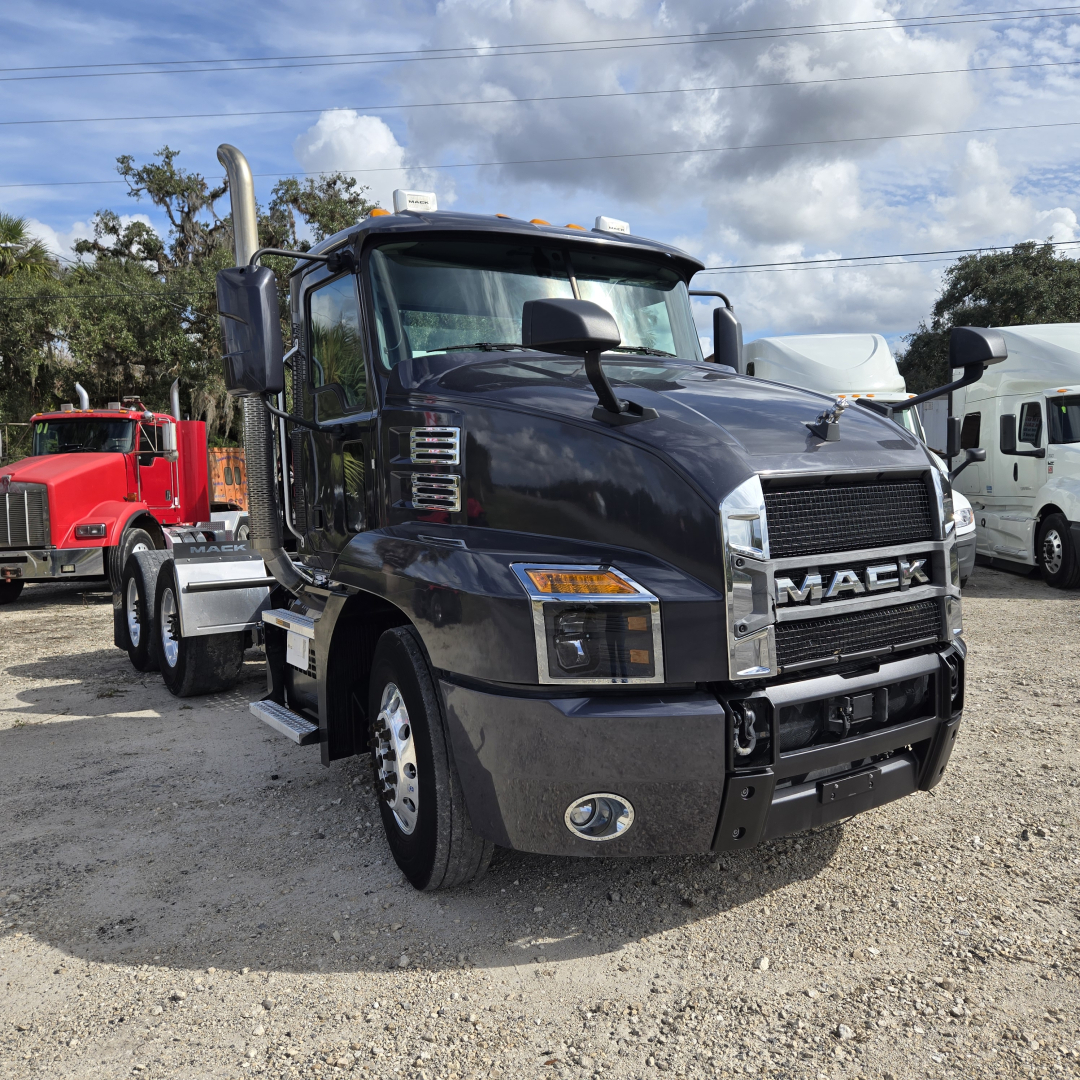 Truck front-left view of a black 2019 Mack ANTHEM day cab with chrome grille, large mirrors, and dual exhaust stacks.