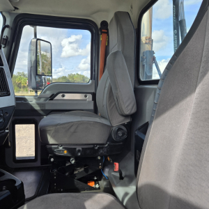 Cab interior of a 2019 Mack ANTHEM day cab truck showing driver seat and surrounding controls.