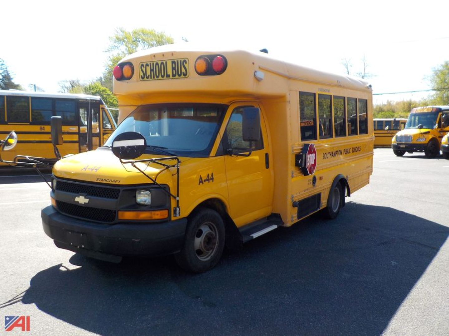 School bus exterior showing Chevrolet engine bay area and yellow body with 'SCHOOL BUS' sign on top.