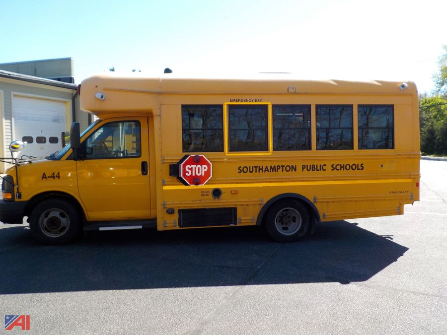 School bus side view showing emergency exit sign, stop sign, Southampton Public Schools, A-44 on front fender, yellow body with black windows