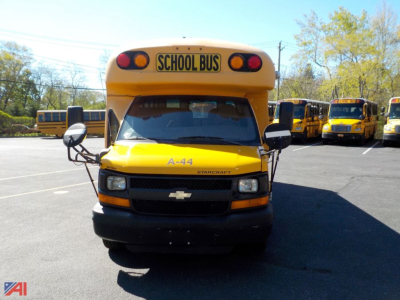 Bus front view showing yellow Chevrolet Starcraft mini school bus with 'SCHOOL BUS' sign on roof and A-44 label on hood.