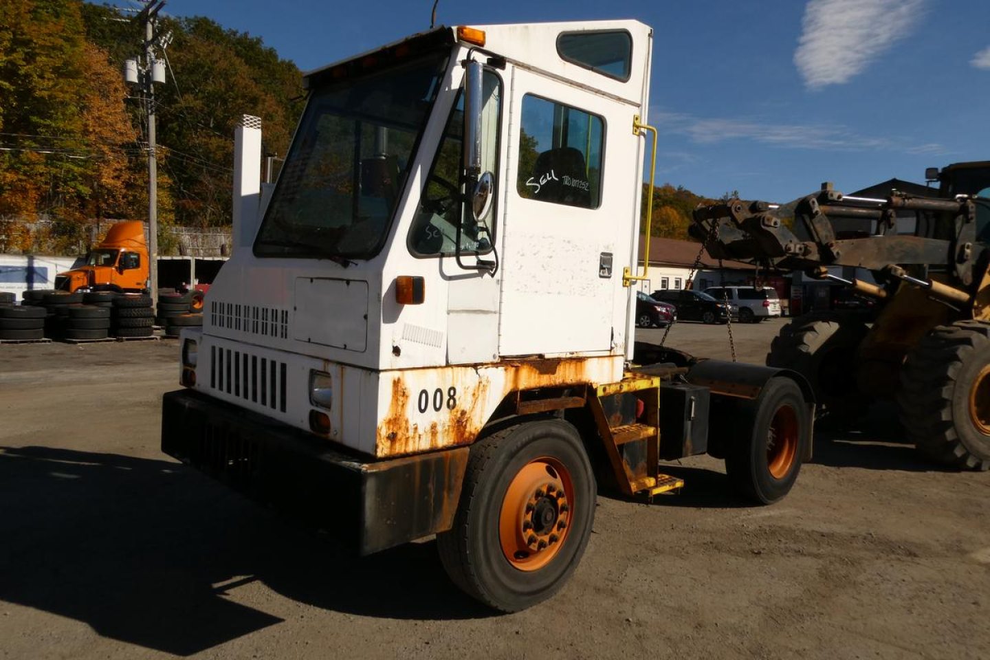 Ottawa 2000 yard truck cab and chassis showing white cab with orange wheels and rusty lower body, VIN 11VA812EXYA000143 visible on door.