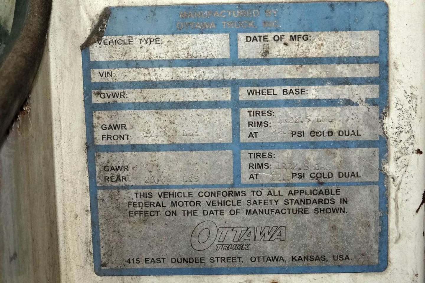Blue model plate on vehicle showing VIN, GVWR, GAWR, wheel base, tires and rims fields, Ottawa Truck logo, address in Ottawa, Kansas.