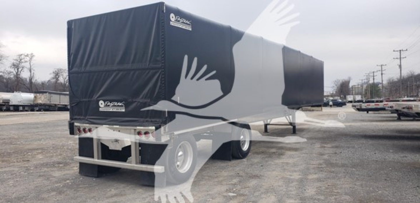 Alum flatbed trailer with curtainside configuration showing Benson logo and rear doors.