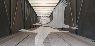 Trailer interior showing empty flatbed trailer with wooden floor and dark side walls, no payload visible.