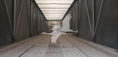 Interior of a Benson flatbed trailer with side curtains and steel ribs, empty cargo area.