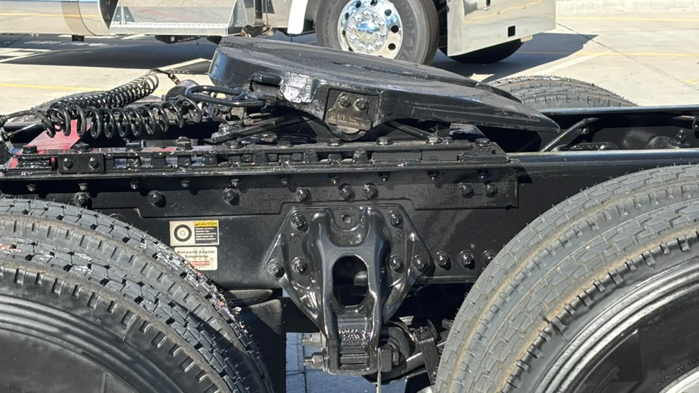 Kenworth T680 chassis view showing coupling hitch area and undercarriage components with dual rear tires.