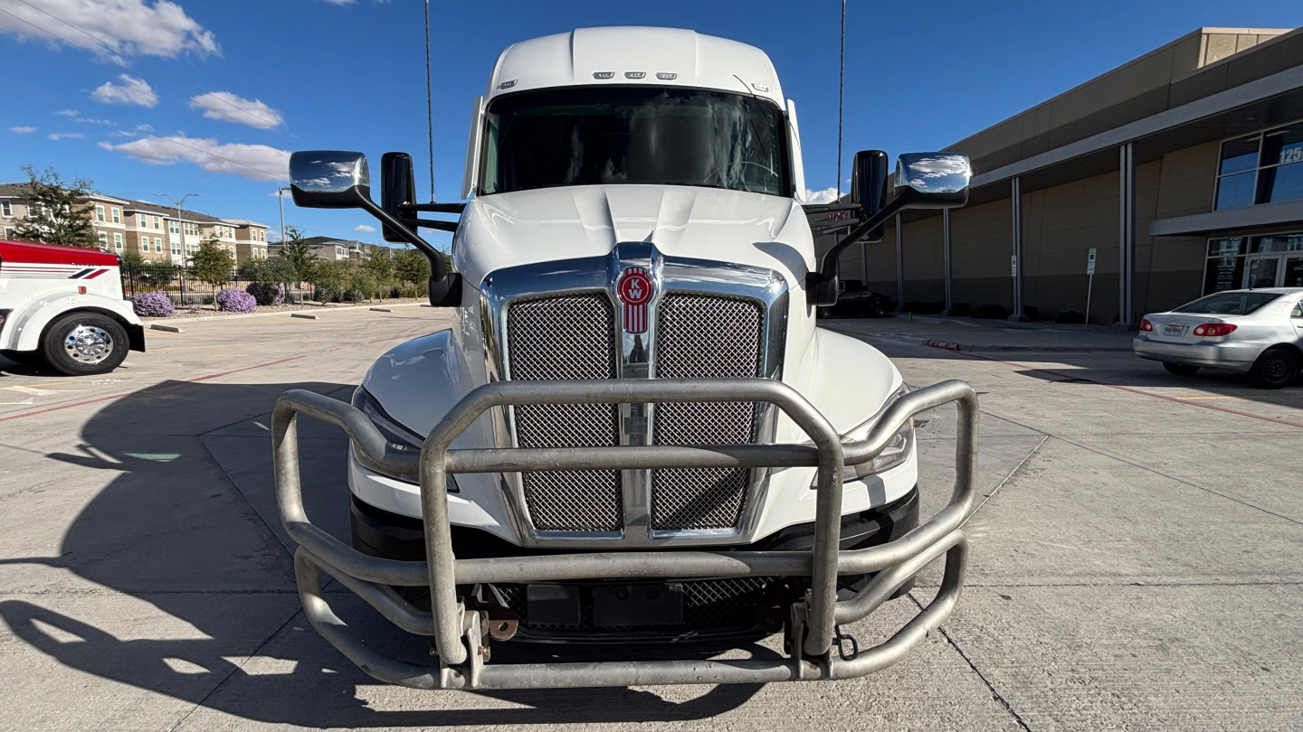 Kenworth T680 front view showing chrome grille, bumper guard, and large mirrors.