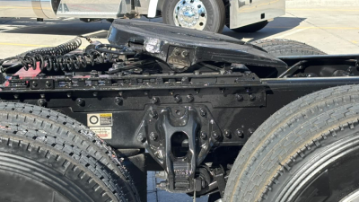 Kenworth T680 chassis view showing coupling hitch area and undercarriage components with dual rear tires.