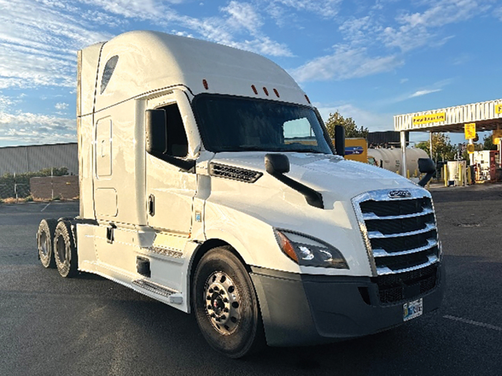 Truck side view showing Freightliner Cascadia126 sleeper cab with long hood and chrome grille.