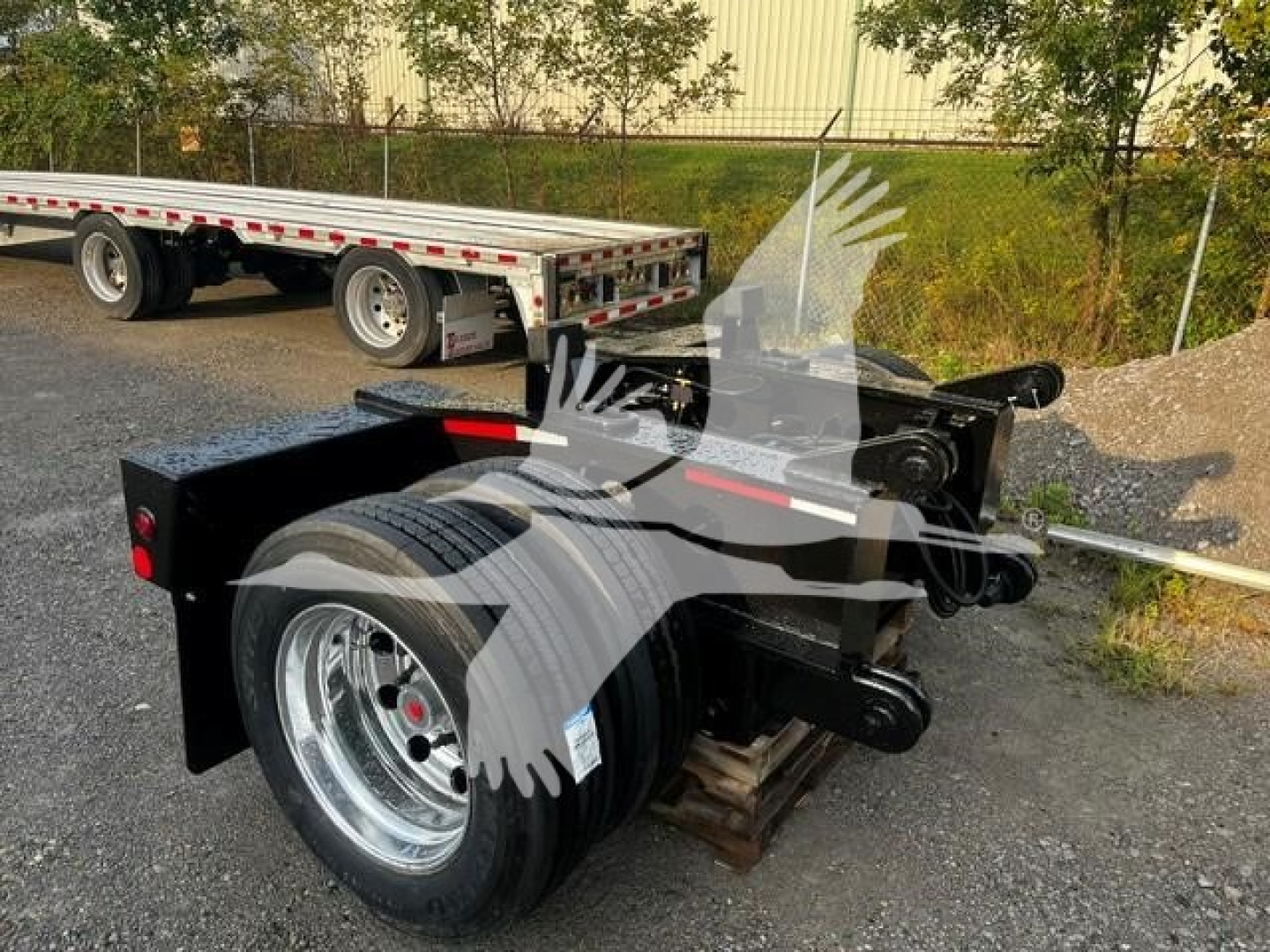New Fontaine flip axle trailer component showing wheel and suspension assembly with chrome wheel and black painted frame.