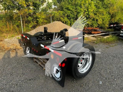 Fontaine flip axle trailer viewed from side/rear showing black frame, rear fenders, and dual axles with chrome wheels.