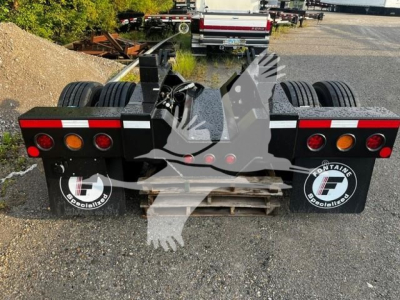  Fontaine Flip Axle trailer rear view showing dual rear axles, taillights, mud flaps with Fontaine Specialized logo, and metal frame.