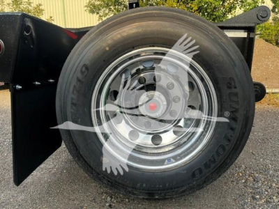 Fontaine flip axle trailer wheel with tire and chrome rim, side view showing hub and lug nuts
