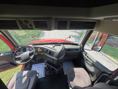 Volvo truck interior cab view showing dashboard and driver seat area.