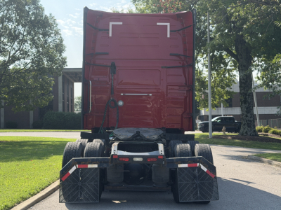 Rear view of a 2022 Volvo VNL64T760 truck with rear sleeper cab, showing dual rear axles and mud flaps.