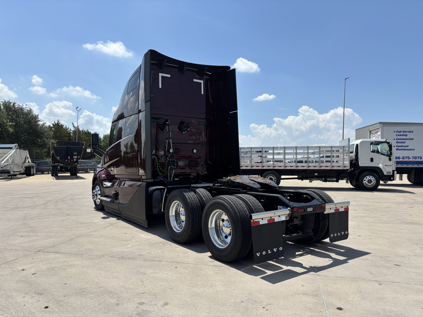 Volvo VNL64T860 tractor cab with rear view showing fifth wheel and dual rear axles in an outdoor lot.