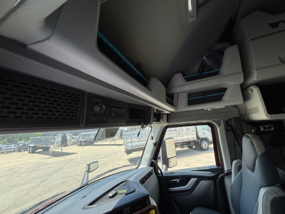 Volvo VNL64T860 cab interior showing dashboard controls and overhead storage.