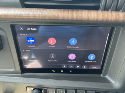 Volvo VNL64T860 dash touchscreen showing Android Auto apps and icons in center console.