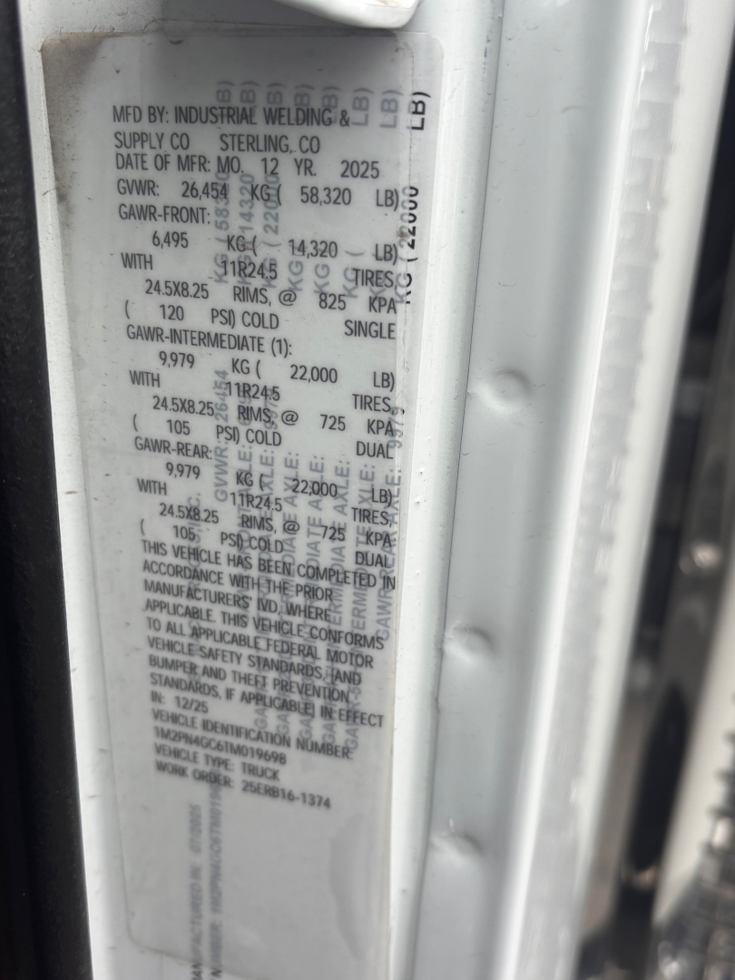 Mack PI64 vehicle door sticker showing manufacturing details: MFD BY INDUSTRIAL WELDING & SUPPLY CO STERLING CO; date of mfr 2025; GVWR 26,454 kg; GAWR values; tire specs.