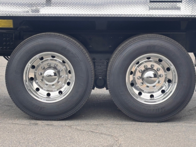 Mack PI64 truck dual rear wheels showing polished chrome rims and tires with black rear suspension and undercarriage