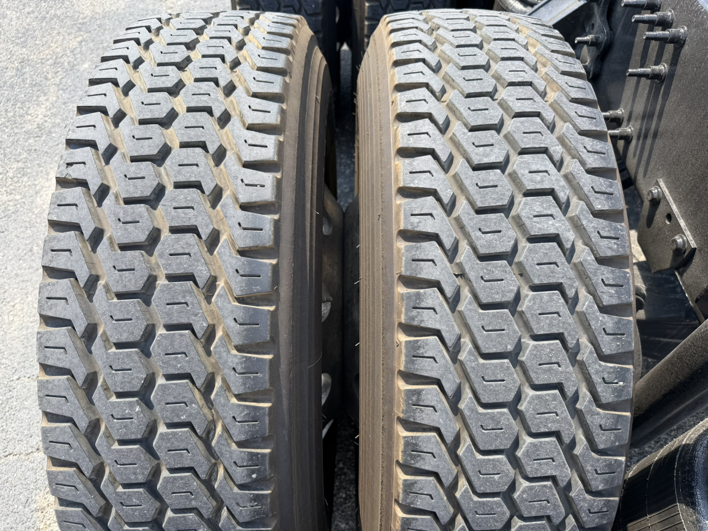Two rear dual tires of a Volvo VNL truck with tread pattern visible.