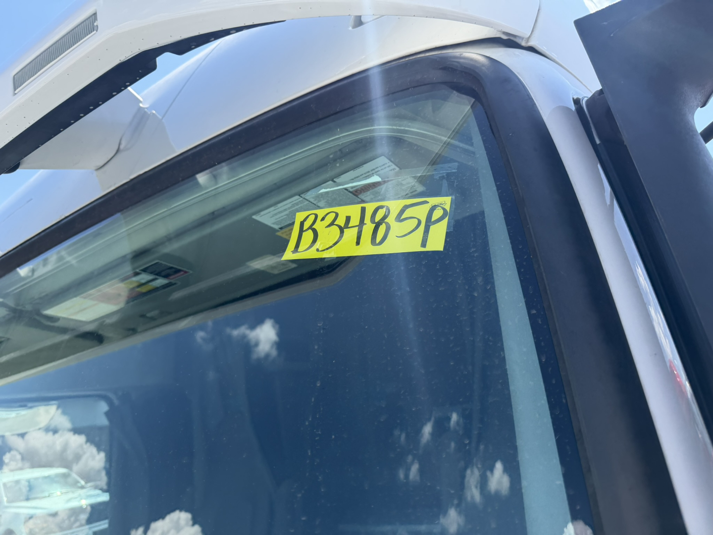 Window sticker showing stock number B3485P on a Volvo VNL64T740 truck cab window.