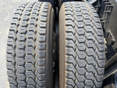 Two rear dual tires of a Volvo VNL truck with tread pattern visible.