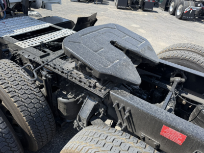 Volvo VNL64T740 truck chassis area showing fifth wheel cover and fuel/accessory mounts with tires and frame components visible.