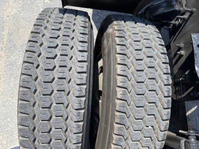 Volvo VNL64T740 tractor rear dual tires showing tread patterns and wheel wells.