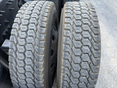 Volvo VNL64T740 truck dual rear tires showing tread pattern and wheel rims.
