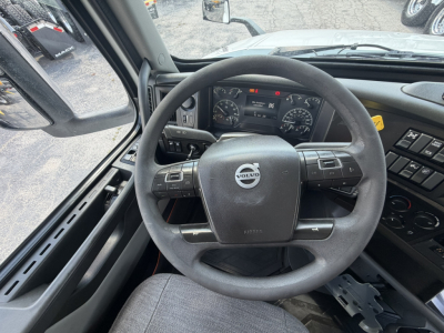 Volvo steering wheel and dashboard inside truck cab, view from driver seat in a 2021 Volvo VNL64T740.