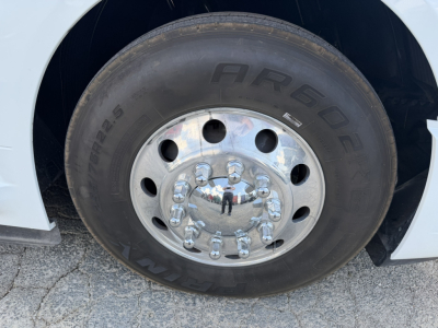 Truck wheel with AR 6OE tire and chrome hubcap. Visible text includes ARS60? on tire, and numbers around lug nut area; no other readable labels.