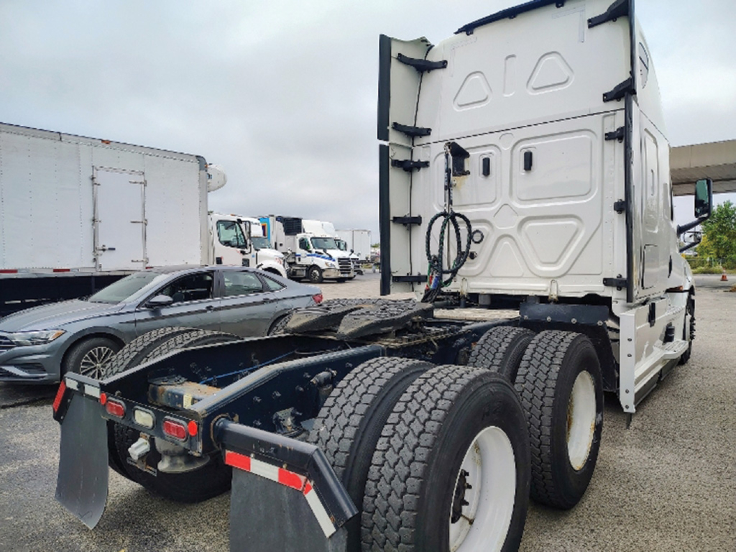 Truck chassis and cab rear view showing heavy-duty dual rear axles and fifth-wheel area for a Freightliner Cascadia126.