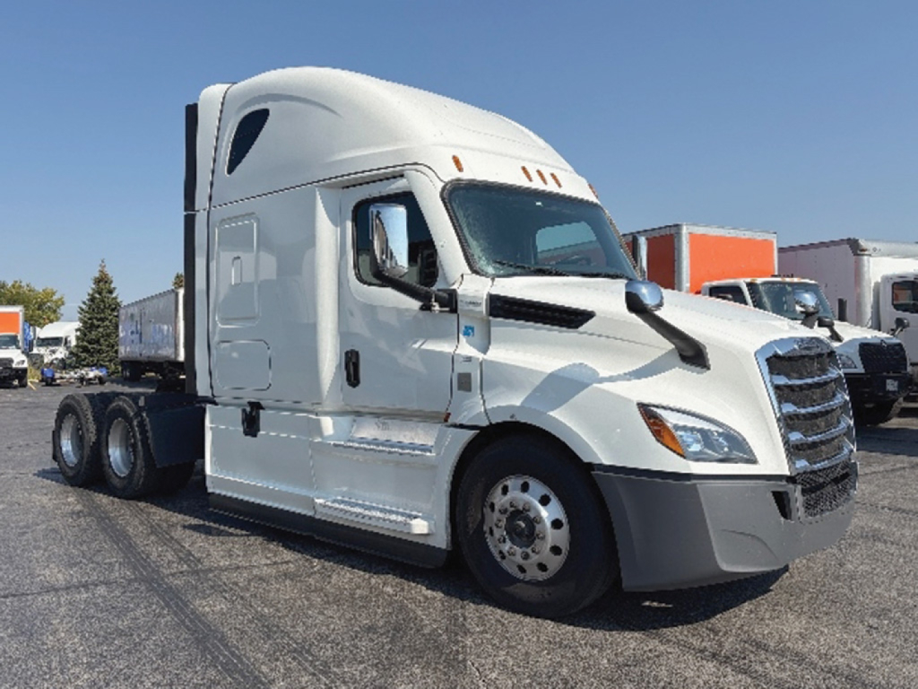 Freightliner Cascadia126 in-service truck tractor, side view showing sleeper cab, front grille, and fuel/engine components.