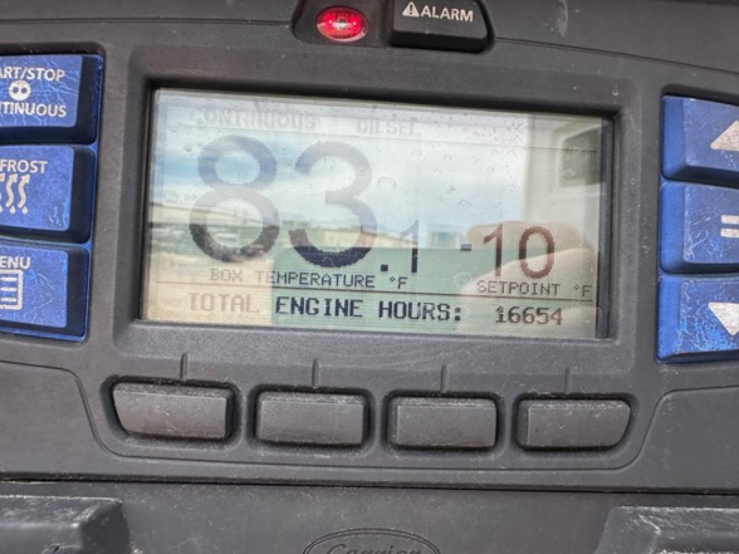 Trailer cab instrument panel showing 83.1 and total engine hours 16654, with various blue control buttons around.